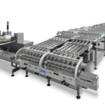 SPS Italiana Pack Systems high-speed horizontal flow-pack packaging machine for biscuits cookies and chocolate bars - integrated pick-up portioning and loading - interpack Düsseldorf 2026